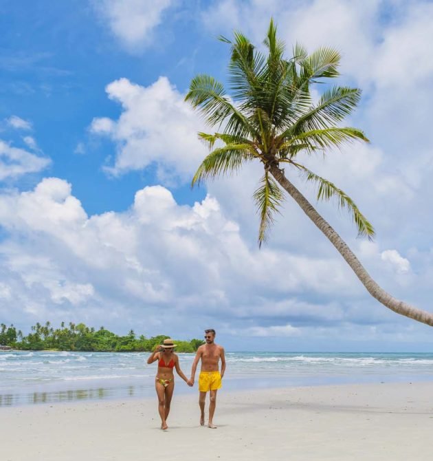 diverse multiracial couple on vacation at oh Kood Island Thailand Trat, a couple of men and women relaxing at a hanging palm tree on a sunny day